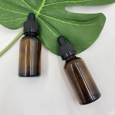 O cosmético 30ml de vidro ambarino engarrafa o óleo essencial com o conta-gotas do fechamento da catraca